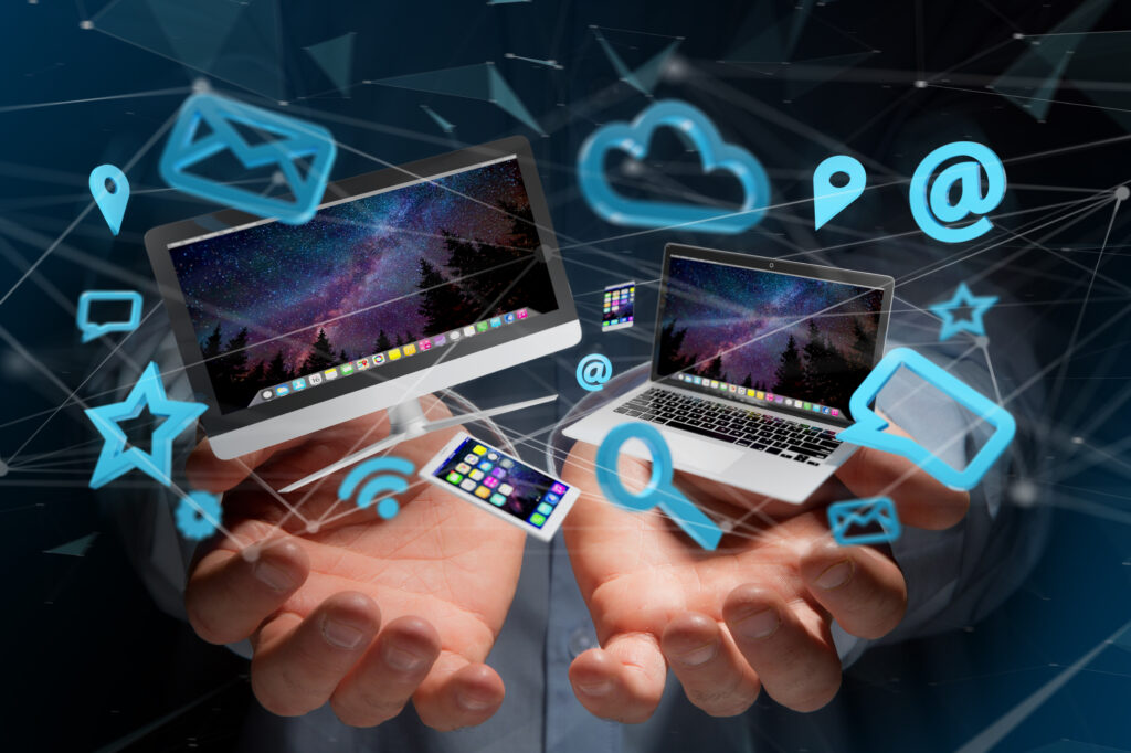 Two hands appear to release digital icons and laptop holograms, symbolizing modern technology and connectivity in a dynamic composition managed by a Service Provider (MSP).